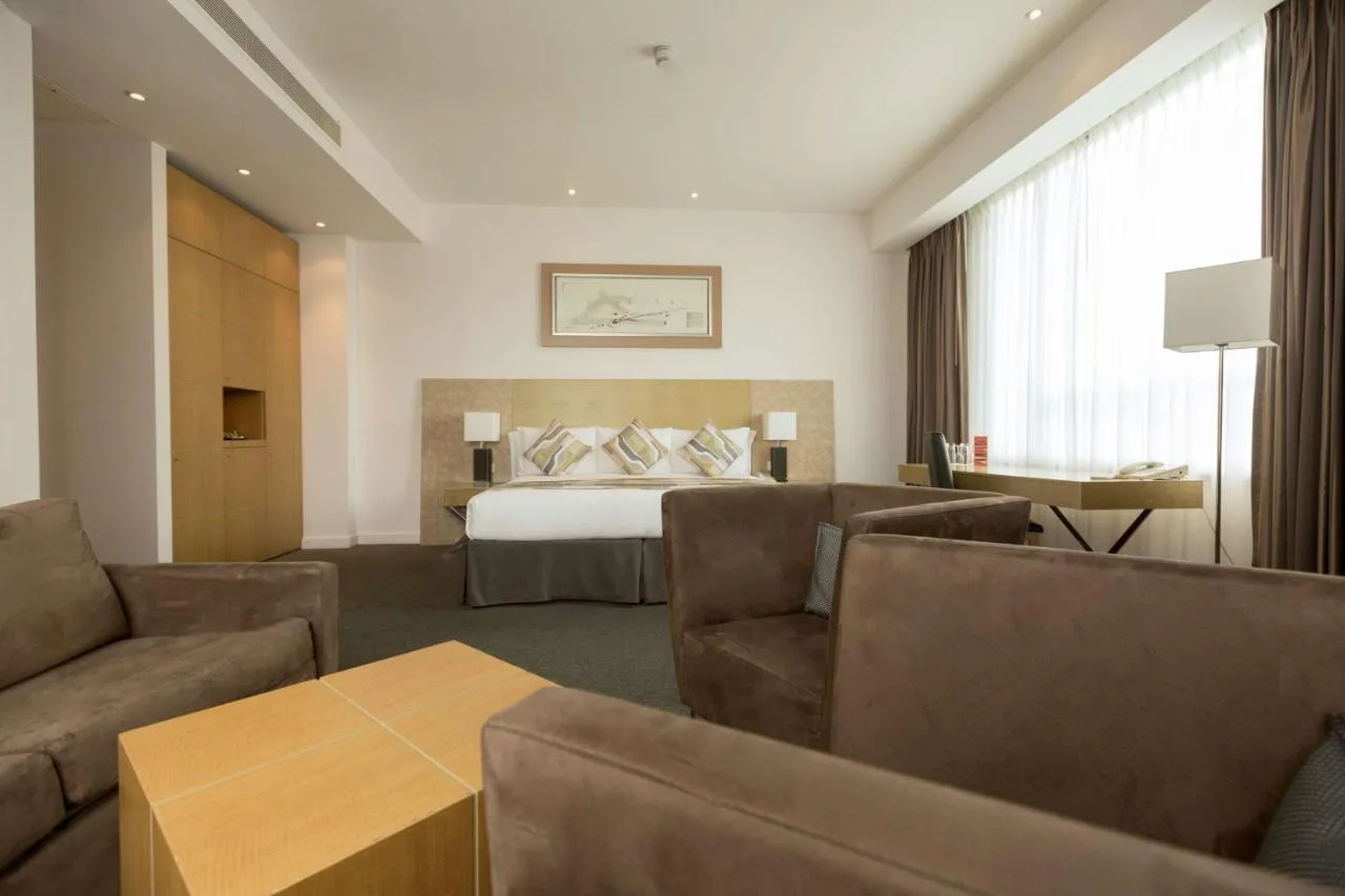 a hotel room with a bed and a couch at Park Plaza Cardiff in Cardiff